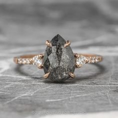 a black diamond ring with three diamonds on it