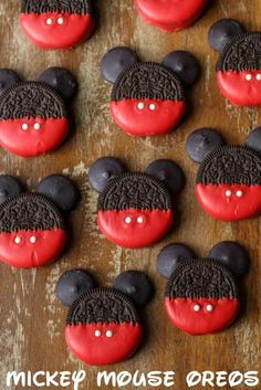 mickey mouse oreo cookies with red frosting and black ears on wooden table top