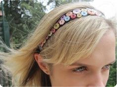 a woman with blonde hair wearing a headband made out of donuts