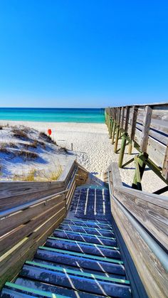 the stairs lead down to the beach from the sand