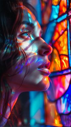 a woman with her face close to the stained glass window