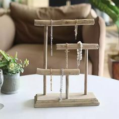 a small wooden stand with jewelry on it