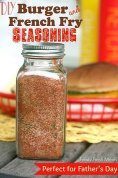 a mason jar filled with french fry seasoning sitting on top of a wooden table