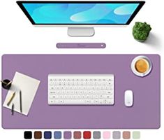 a computer desk with a keyboard, mouse and color swatches