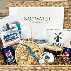 a basket filled with food and drinks sitting on top of a table