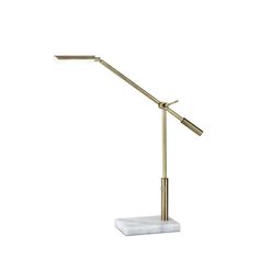 a brass and marble desk lamp on a white background