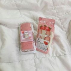 two packaged strawberry shorties sitting on top of a bed