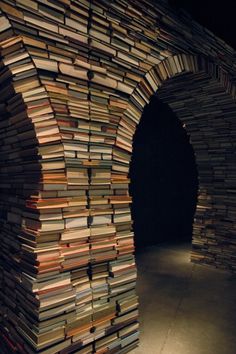 an arch made out of books is lit up by the light coming from behind it