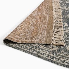 an area rug with fringes on top of it