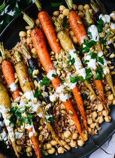 carrots, beans and other vegetables are on a plate