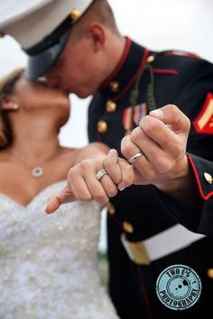 a bride and groom are kissing in front of an officer's kiss on the cheek