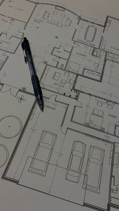 a pen sitting on top of a blueprint drawing