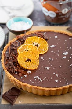 a chocolate tart with orange slices on top