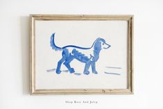 a watercolor painting of a blue dog in a frame on the wall next to a white wall