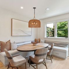 a dining room table with chairs and a bench