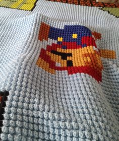 a crocheted blanket with a cartoon character on it