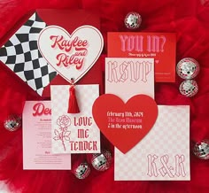 valentine's day cards and other items on a red tulle skirt with checkered background