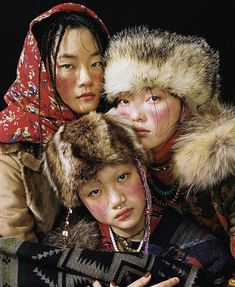 three women with fur hats and scarves on their heads