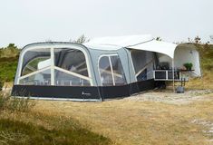 a tent set up in the middle of a field