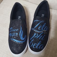 a pair of black shoes with blue sequins and the words teach me delta written on them