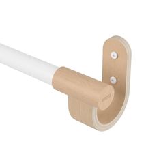 a white and wood handle on a wall mounted toilet paper dispenser with two holes