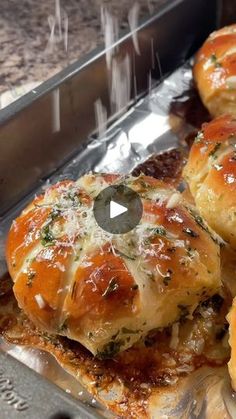 rolls covered in cheese sitting on top of tin foil