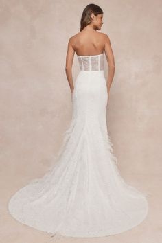 a woman in a white wedding dress looking back