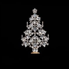 a crystal christmas tree ornament with lots of diamonds on it's sides