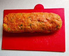 a piece of bread sitting on top of a red cutting board