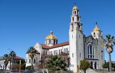 an old church with golden domes and palm trees