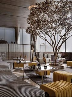 a living room filled with furniture and a tree in the middle of it's center