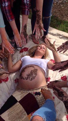 a woman laying on the ground covered in hendikes with her hands and feet spread out