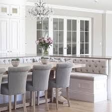 a dining room table surrounded by gray chairs