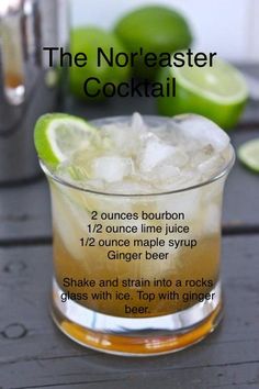 a glass filled with ice and lime on top of a table