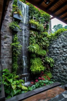 an outdoor waterfall in the middle of a garden with lots of greenery on it