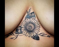 a woman's chest with a sunflower tattoo on it