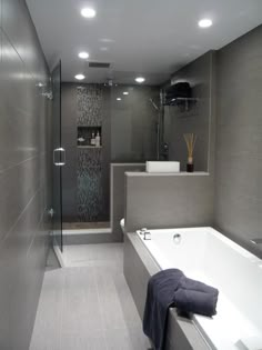 a bathroom with a bathtub, sink and shower stall in the middle of it