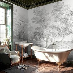 a bathroom with a tub, sink and wallpapered walls in black and white