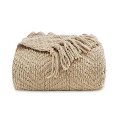 the woven clutch bag is made from natural materials and has fringes on one side