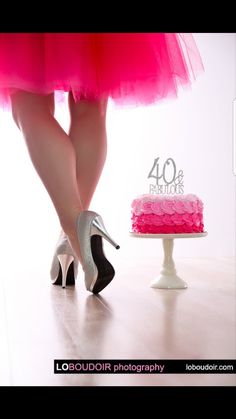 a woman in high heels standing next to a cake with the number 40 on it