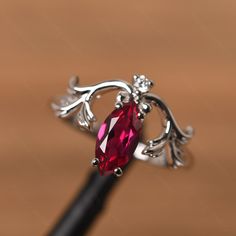 It is a ruby ring. The main stone is 5 mm* 10 mm marquise cut. weight about 1.34 carats. The basic metal is sterling silver and plated with rhodium. To change the metal to a solid gold (white/rose) or platinum is also available, please ask for a quotation if you want. You can also go to my shop Home for more elegant rings: https://www.etsy.com/shop/godjewelry?ref=hdr_shop_menu Alexandrite is June birthstone More alexandrite rings: https://www.etsy.com/shop/godjewelry?ref=seller-platform-mcnav&se Ruby Jewelry With Marquise Cut For Gifts, Silver Promise Ring With Lab-created Ruby, Sterling Silver Marquise Birthstone Jewelry, Silver Marquise Cut Ruby Promise Ring, Elegant Silver Ruby Ring With Marquise Cut, Silver Marquise Ruby Ring For Anniversary, Silver Marquise Cut Ruby Jewelry, Red Marquise Fine Jewelry, Silver Ruby Jewelry With Marquise Cut