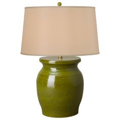 a green ceramic table lamp with a white shade on the base and a beige fabric lampshade