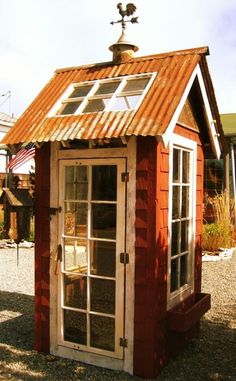 a small red building with a metal roof