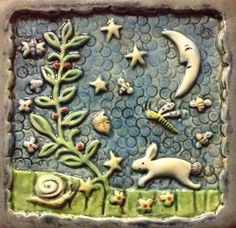 a ceramic tile with animals and stars on it