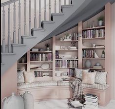 a living room filled with lots of furniture next to a stair case and bookshelf