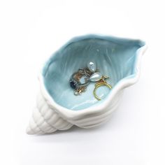 a blue and white bowl with rings in it