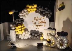 a birthday party with balloons and decorations on the table, including a sign that says happy birthday papa