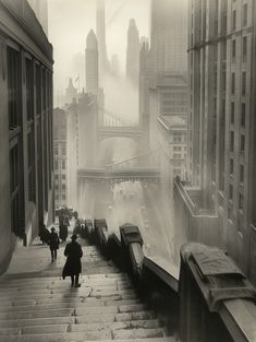 black and white photograph of people walking up stairs in the city on a foggy day