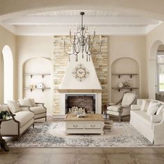 a living room filled with furniture and a fire place under a chandelier over a fireplace