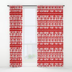 a red and white curtain hanging in front of a window